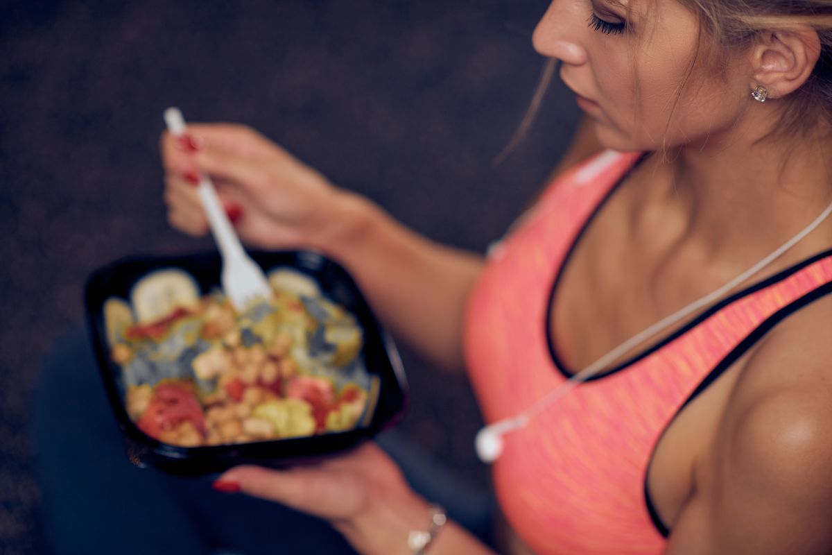 Woman at the gym eating