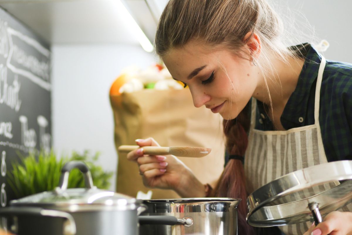 Woman smelling her food on the stove