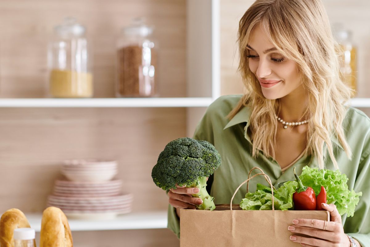 Woman taking vegetables from her paper bag