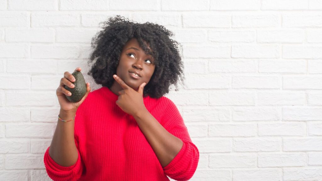 confused woman with avocado