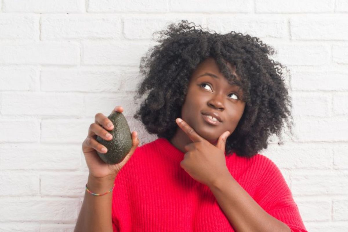 confused woman with avocado