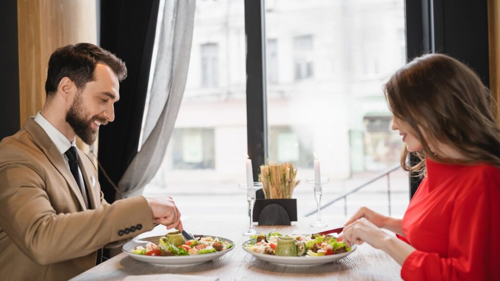 couple dressed formally eating out