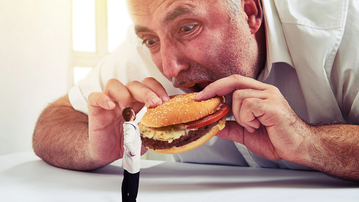 doctor telling man to stop eating