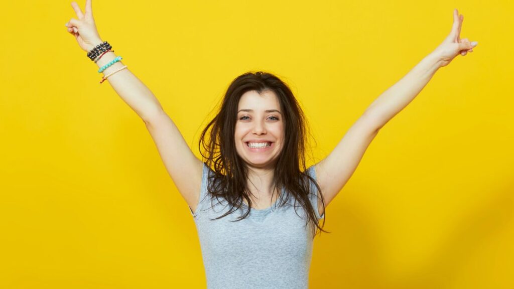 excited woman with arms up