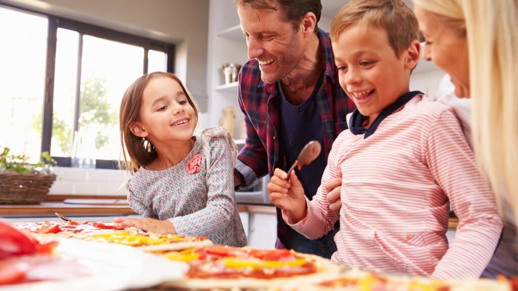 family making pizza