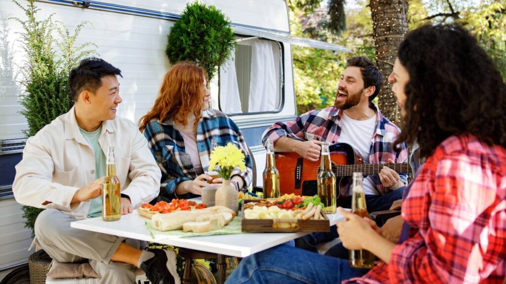 friends together at the table outside rv