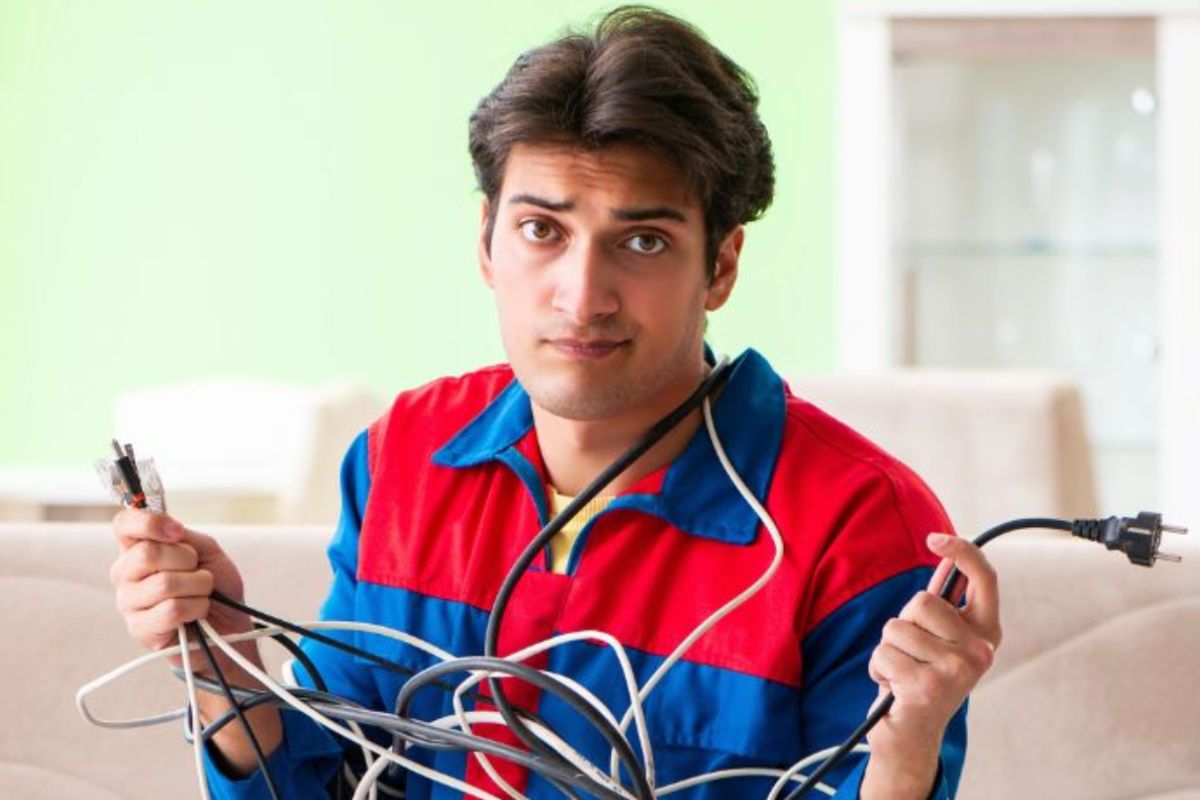 frustrated man tangled in cords