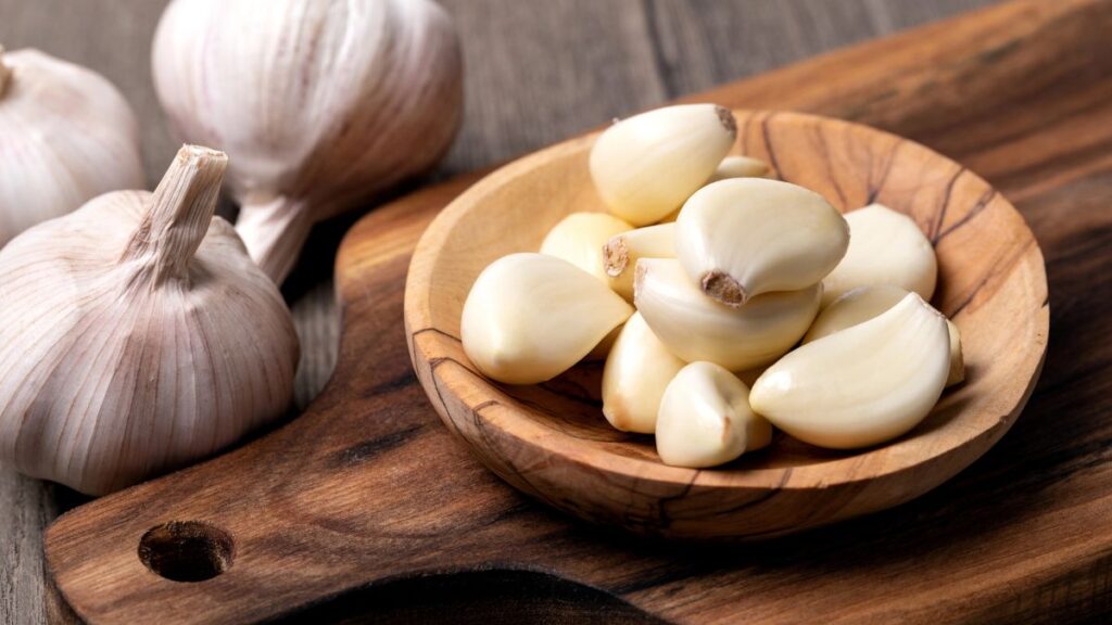 garlic cloves on a board