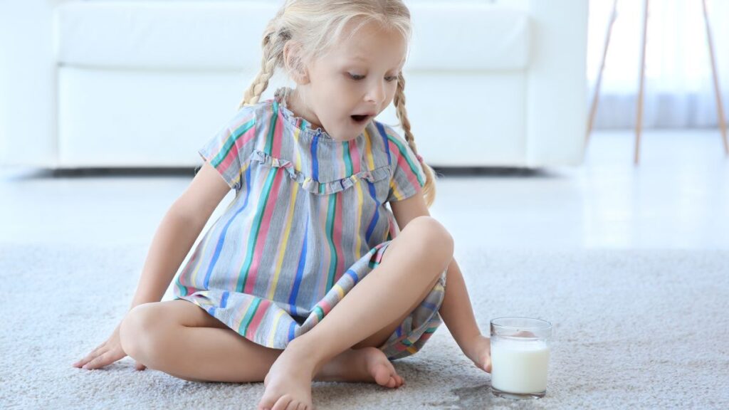 girl surprised with spilled milk