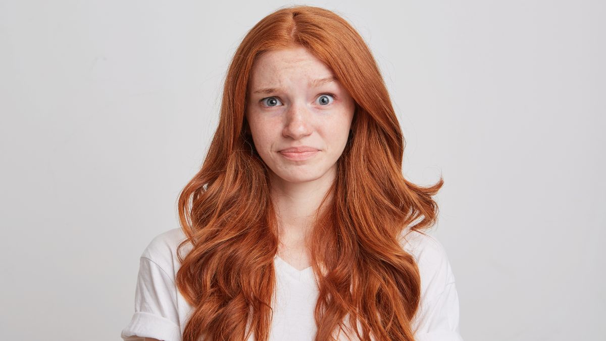 girl looking confused with red hair