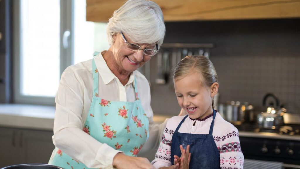 grandma and granddaughter cooking happily