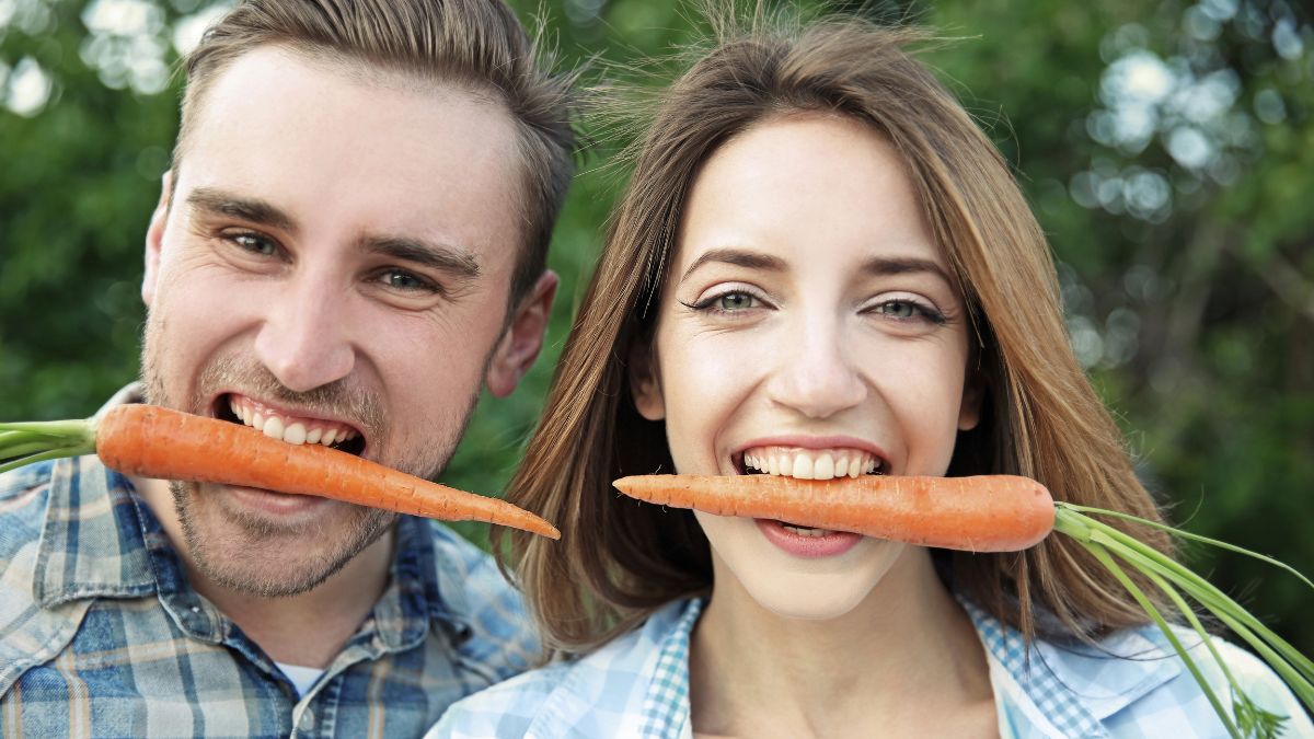 happy couple eating carrots