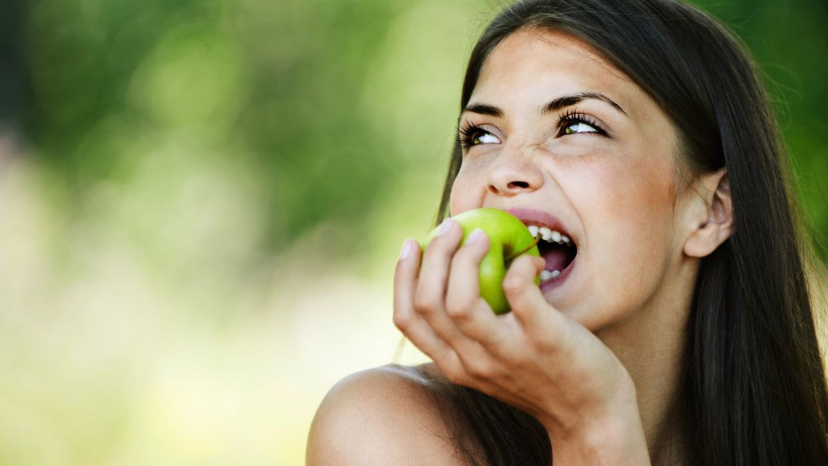 happy woman eating apple