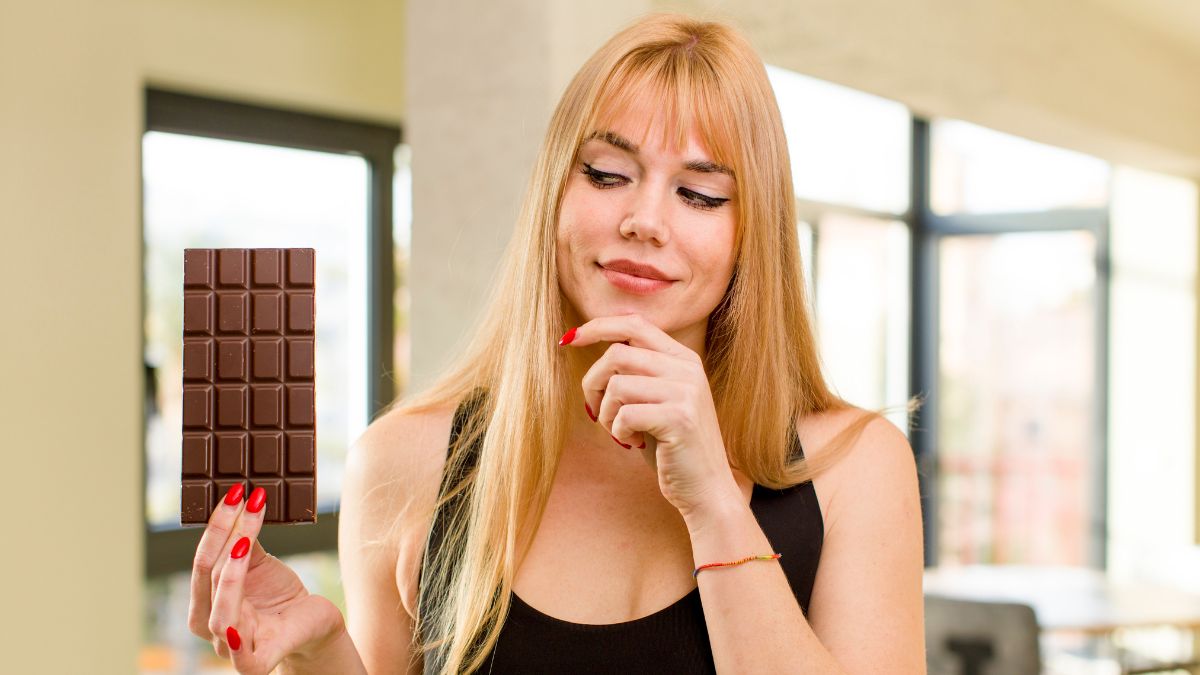 happy woman holding chocolate thinking