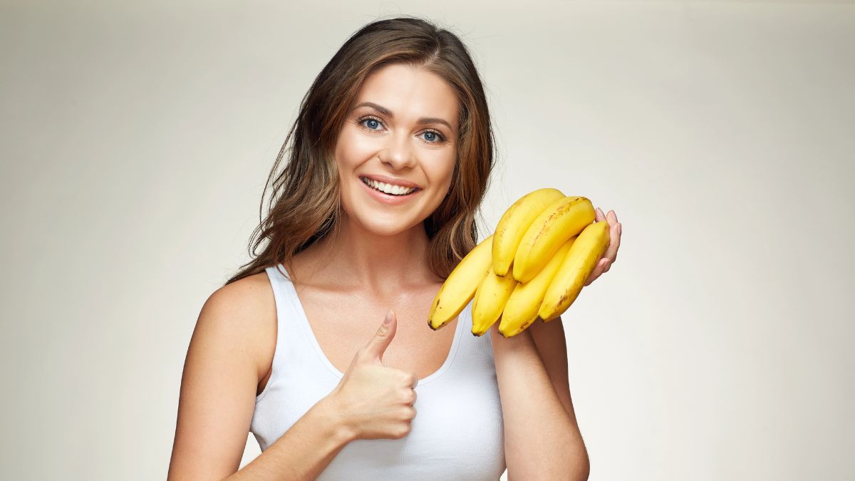 happy woman with bananas giving thumbs up