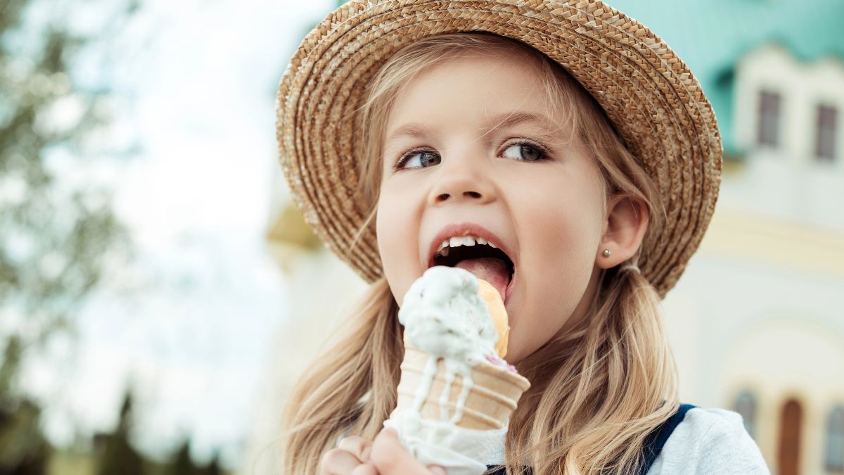 little girl licking ice cream cone