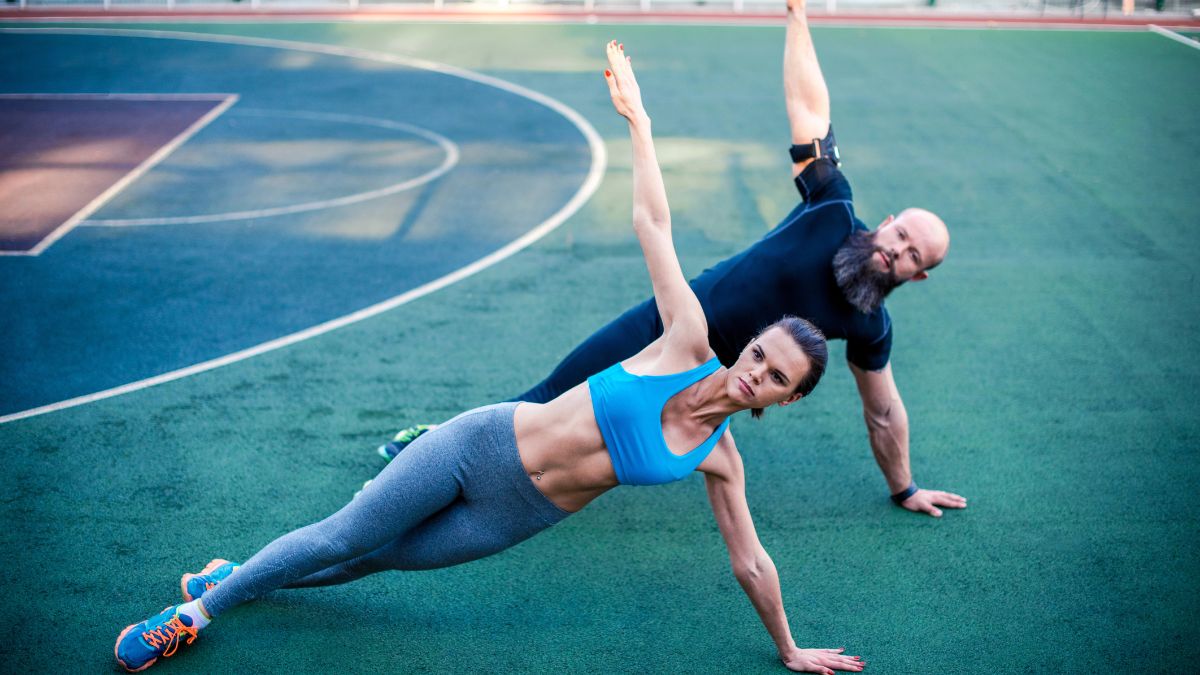 man and woman doing side plank