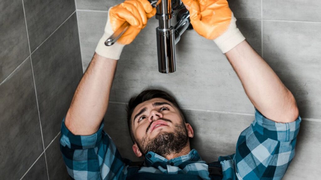 man fixing plumbing