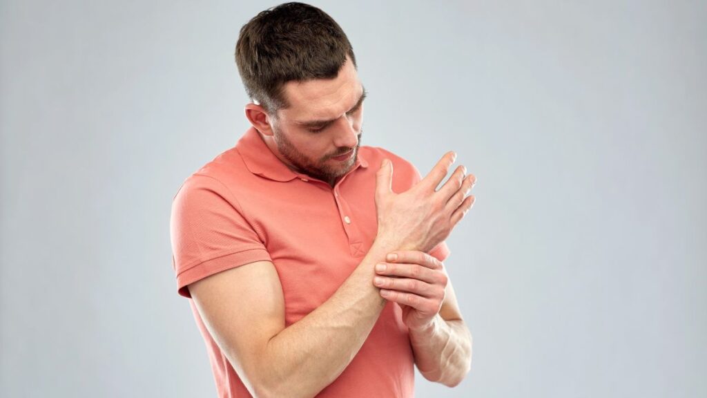 man holding wrist in pain