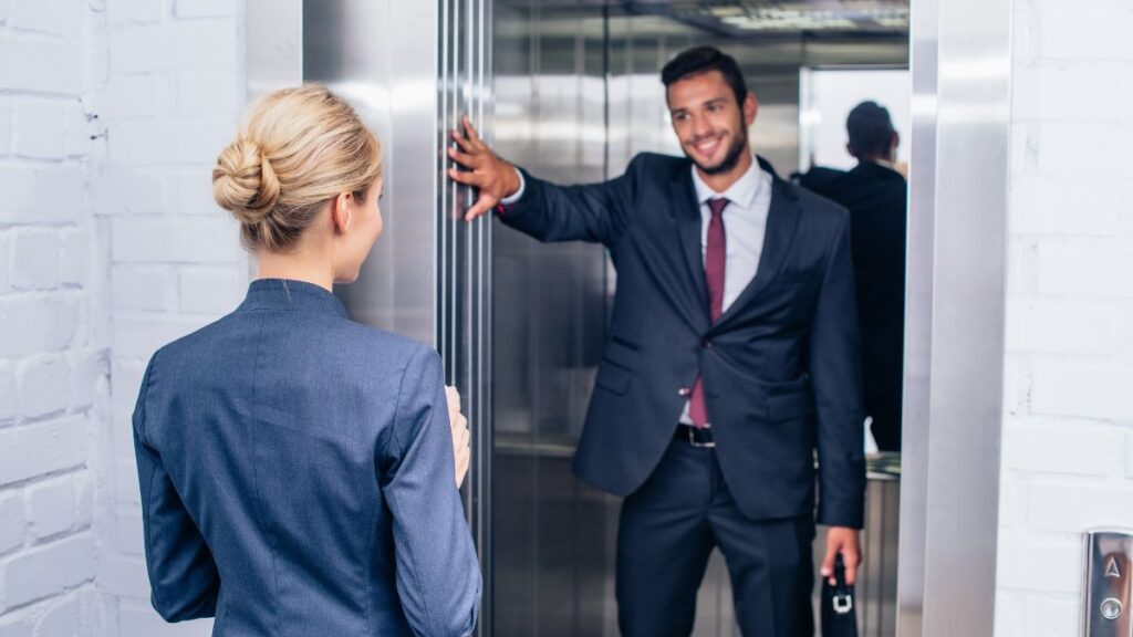 man holing door for woman