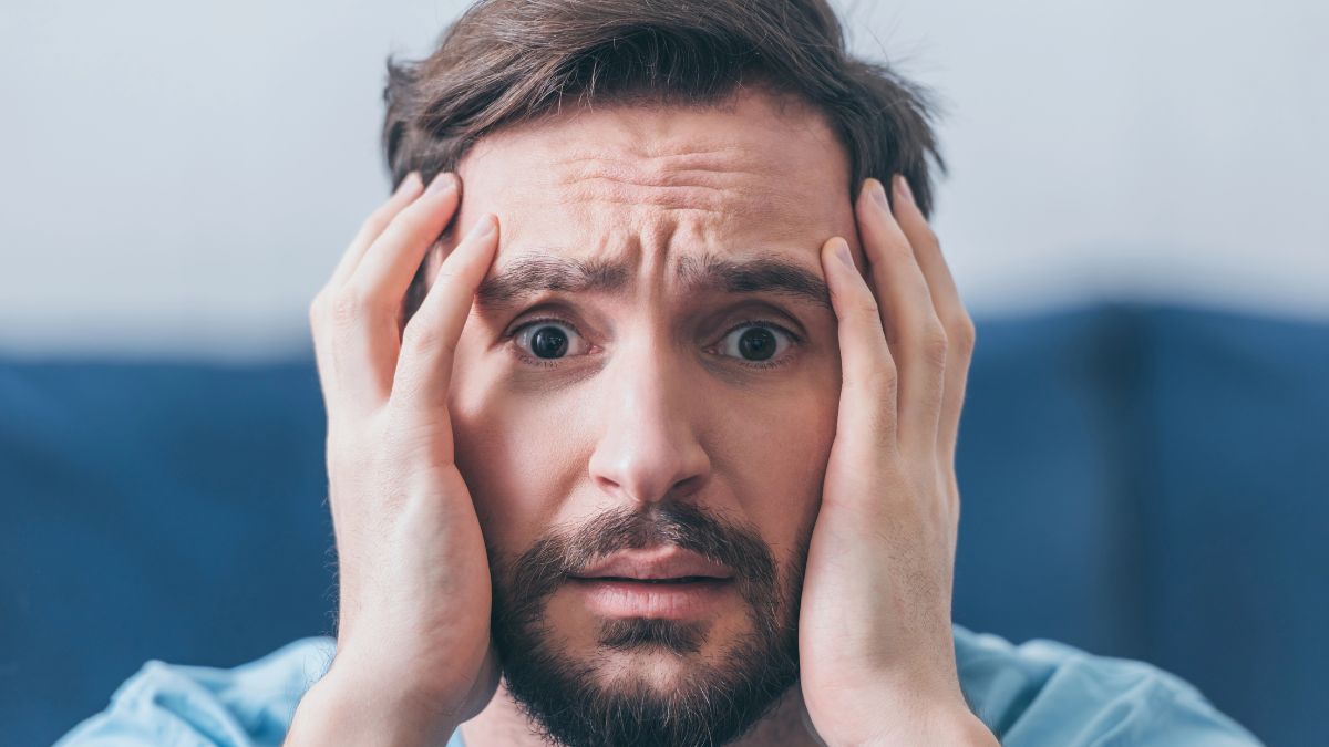 man looking worries with hands on face