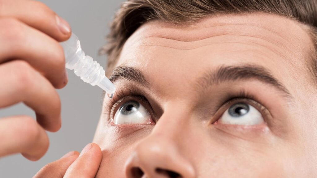 man putting in eye drops