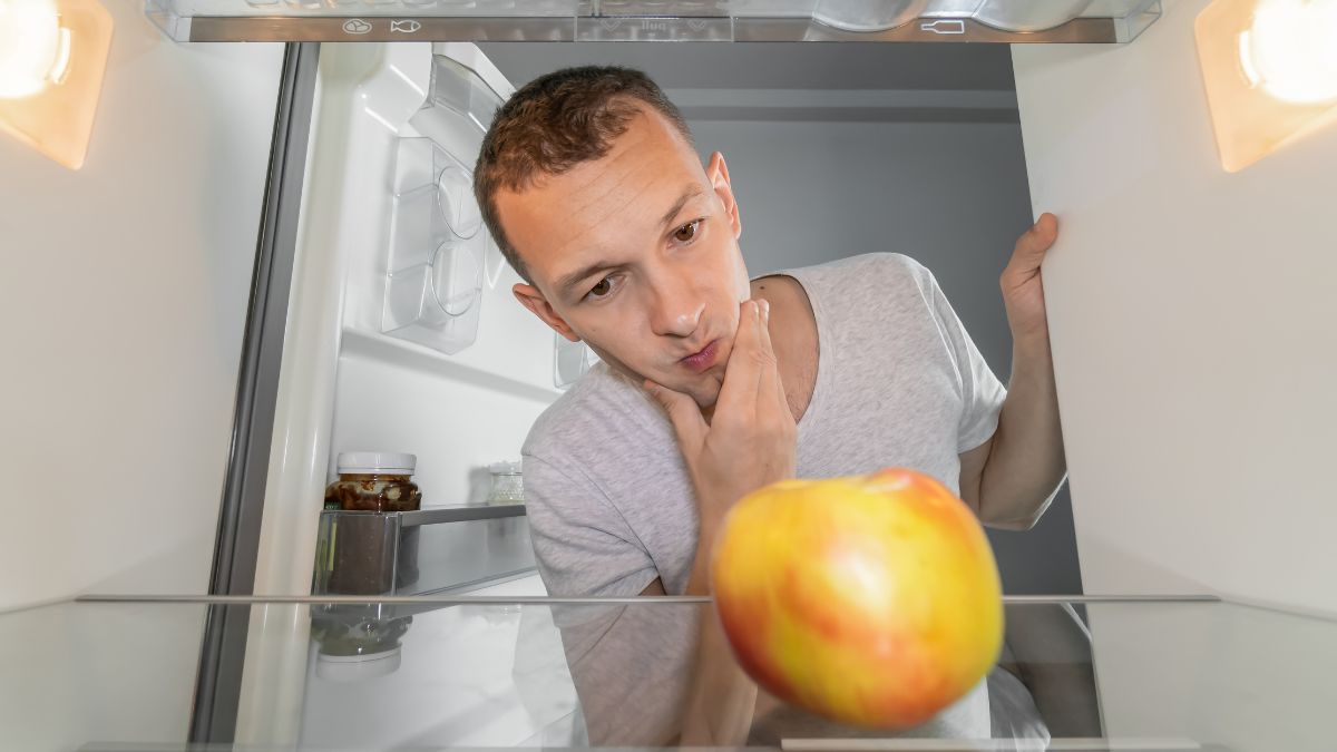 man thinking with hand on chin in freezer