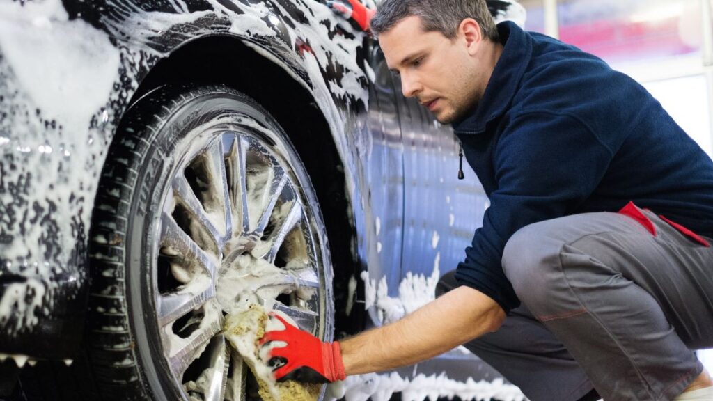 man washing car