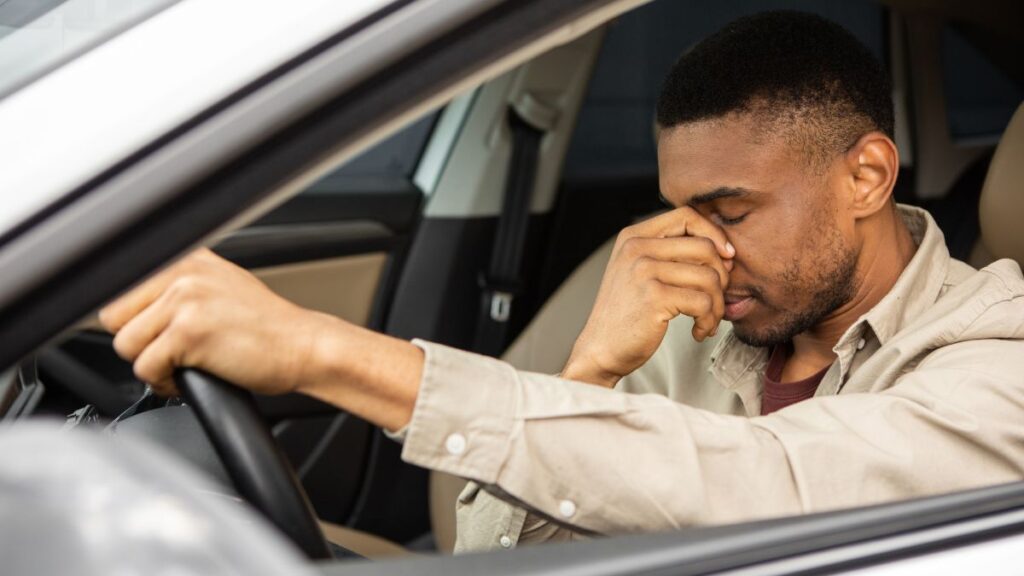 man with hand on nose looking upset