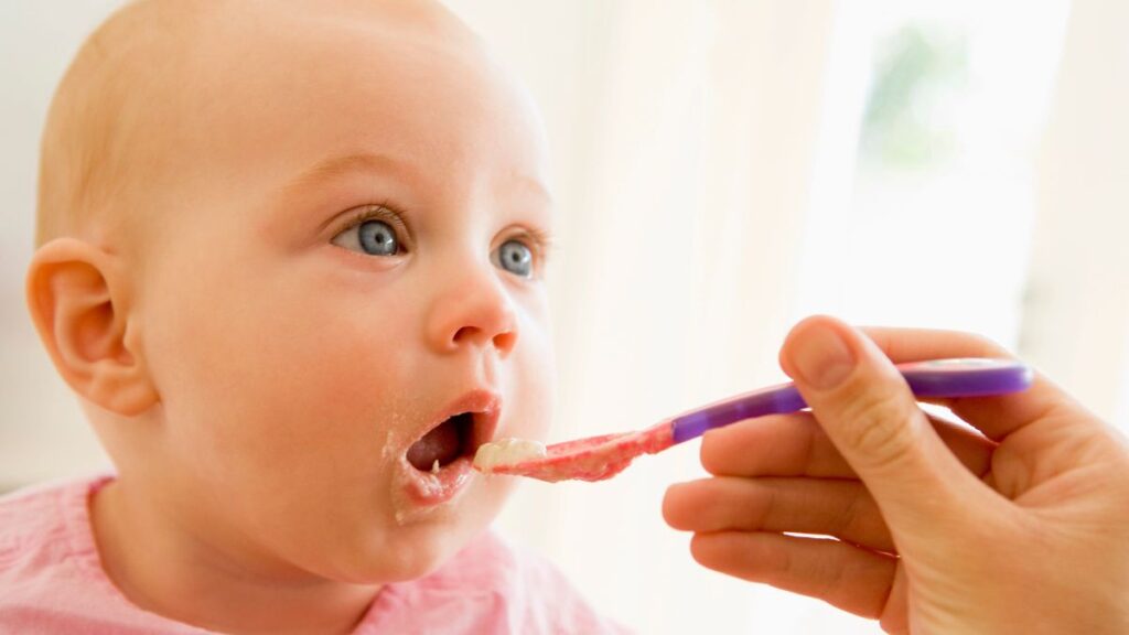 mom feeding baby food