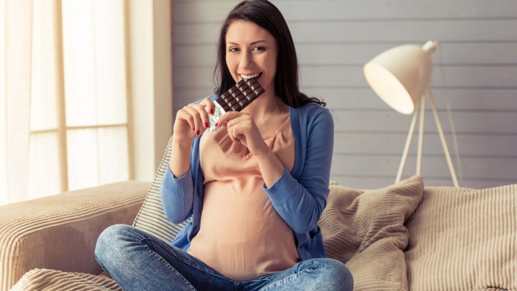 pregnant woman eating dark chocolate