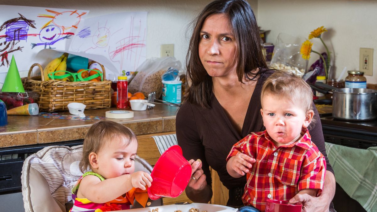 stressed mom in messy kitchen