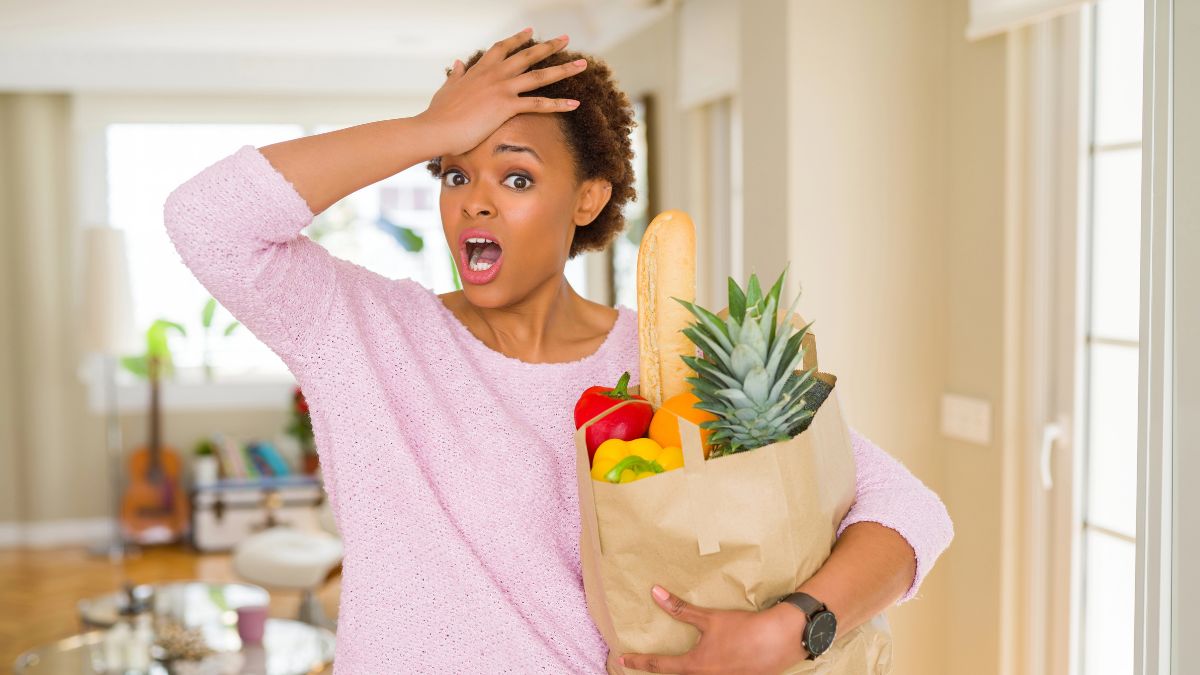 surprised looking woman holding groceries