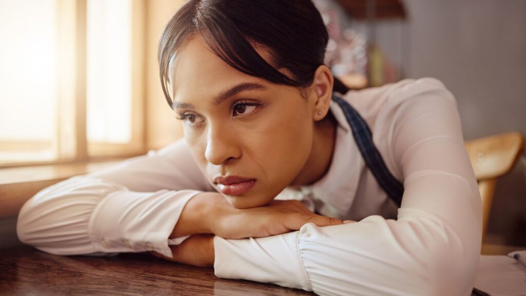 upset waitress with head on table