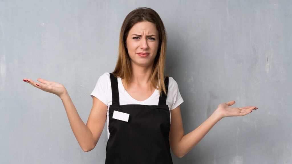 waitress looking unhappy and confused