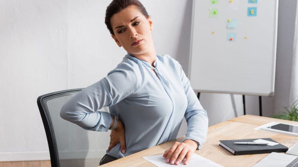 woman at desk with back pain