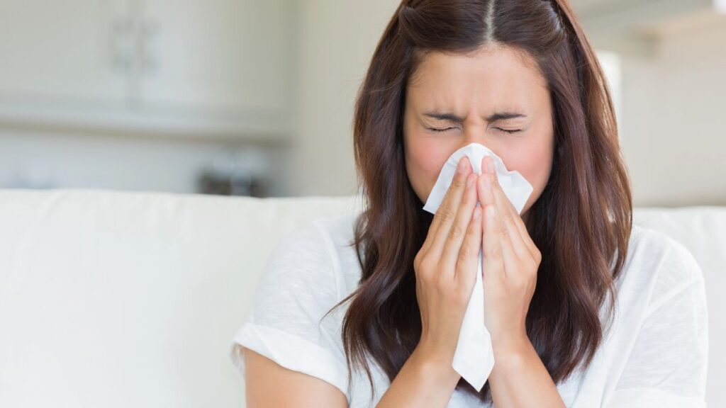 woman blowing nose