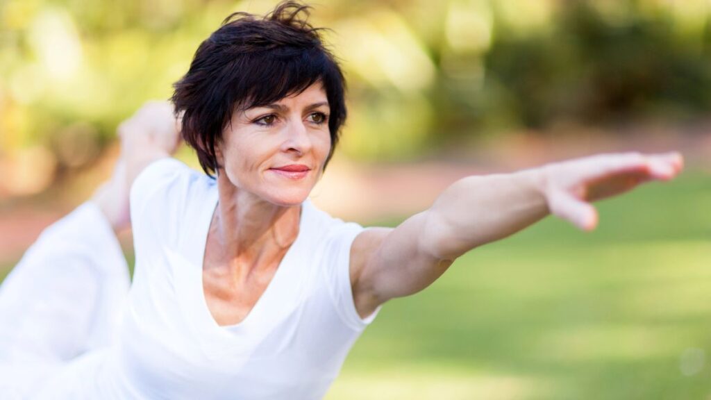 woman doing yoga in white outside