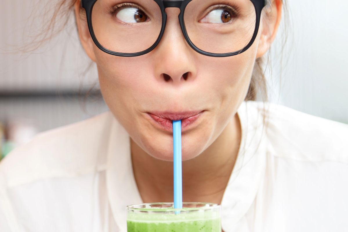 woman drinking a smoothie