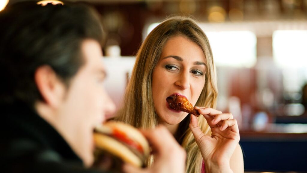 woman eating chicken wing