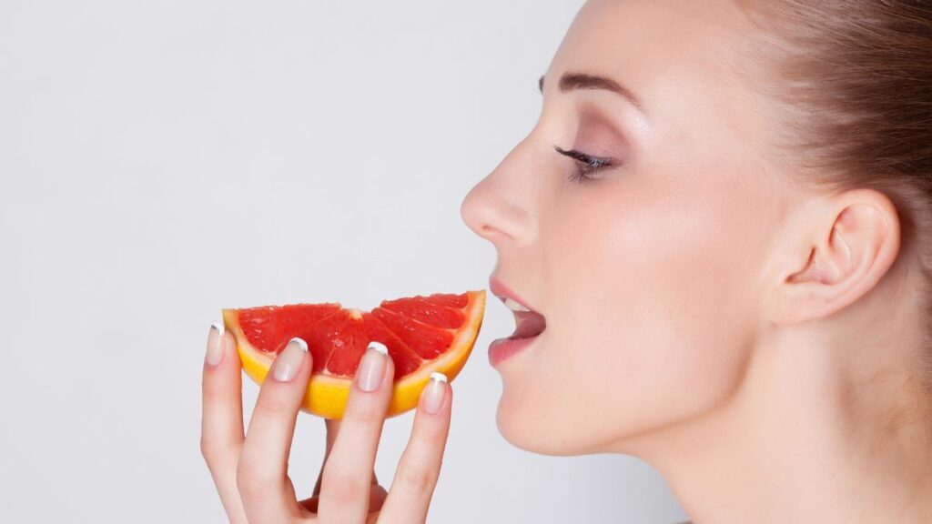 woman eating grapefruit