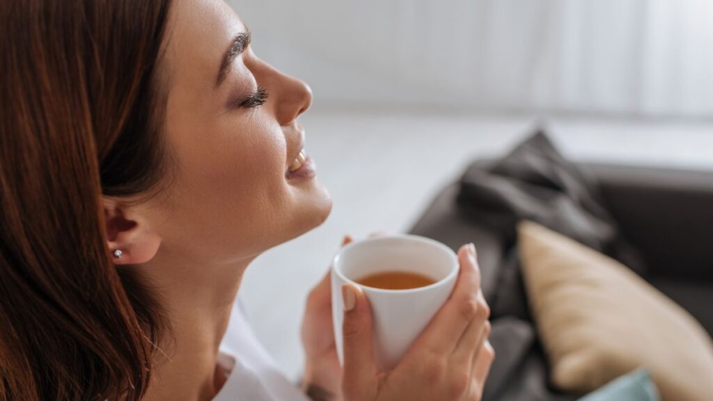 woman enjoying a hot cup of tea