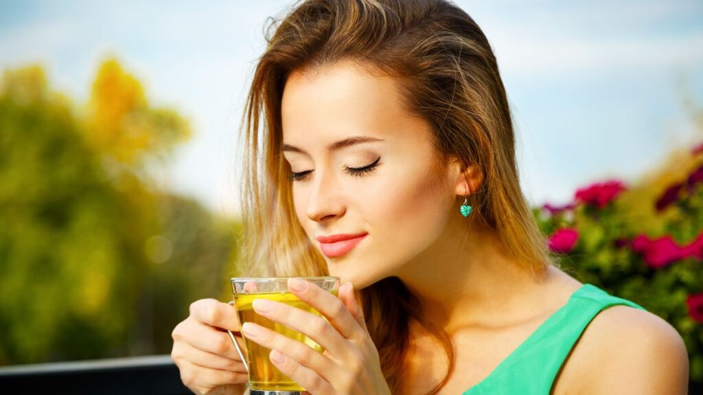 woman enjoying hot green tea