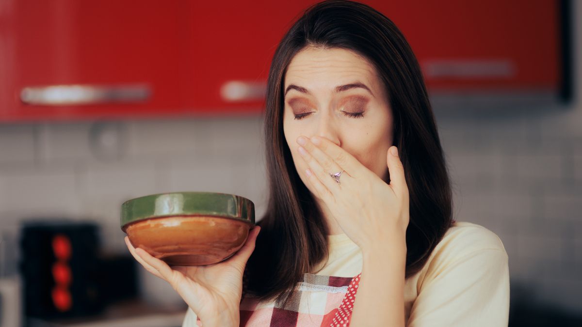 woman feeling sick with bowl