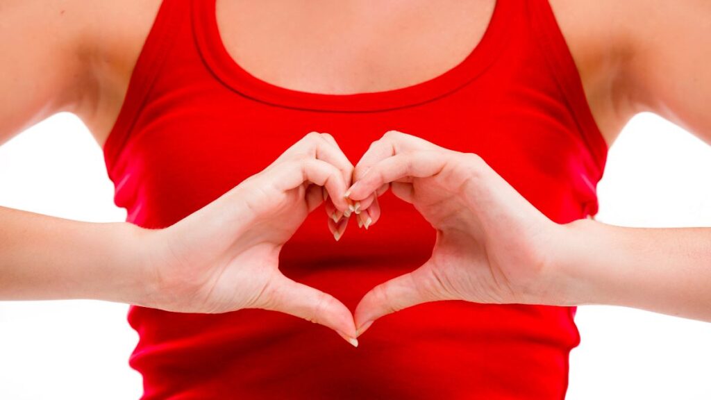 woman in red with hands shaped like heart