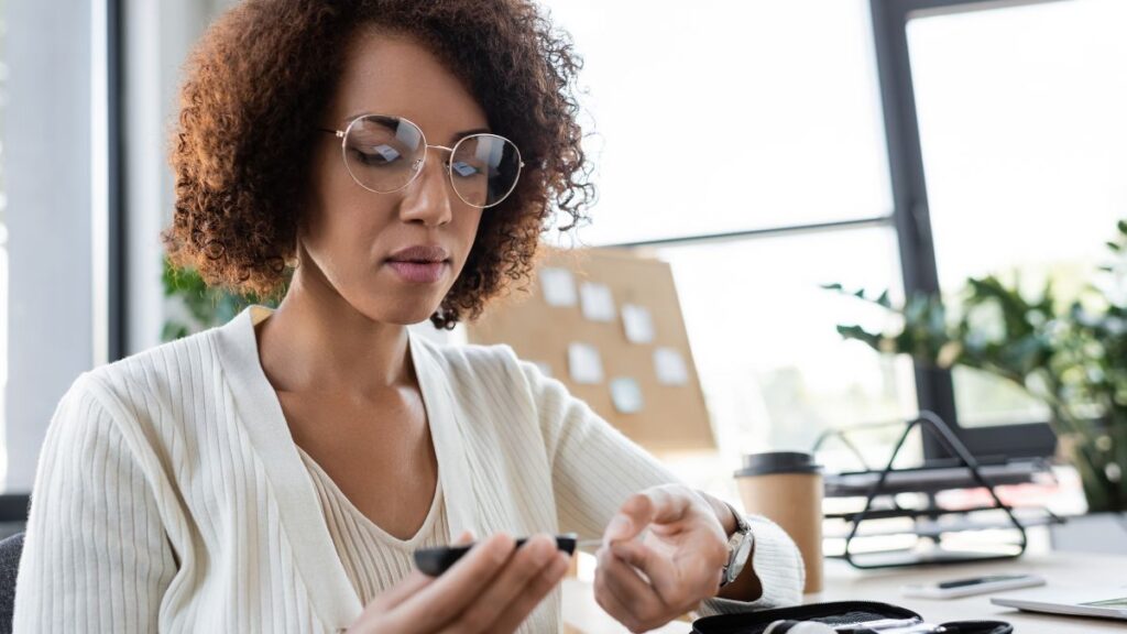 woman in white checking blood sugar