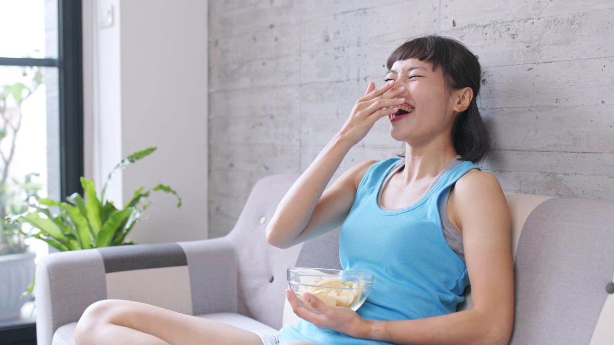 woman laughing with chips