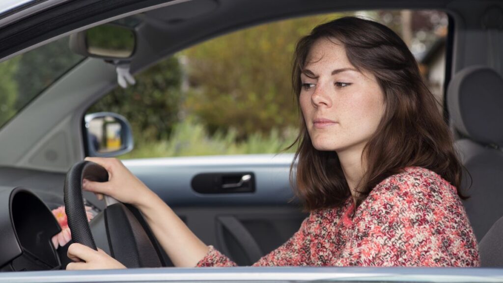 woman looking annoyed in car