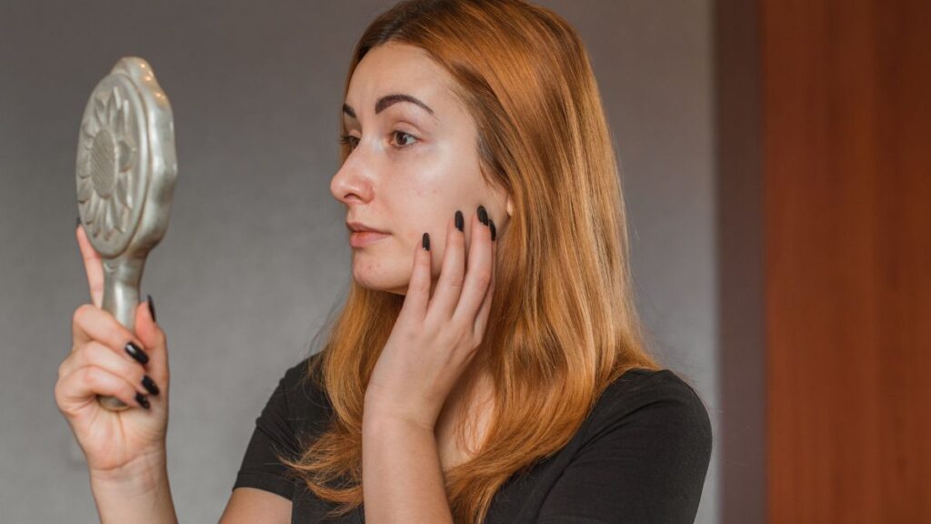 woman looking at face concerned