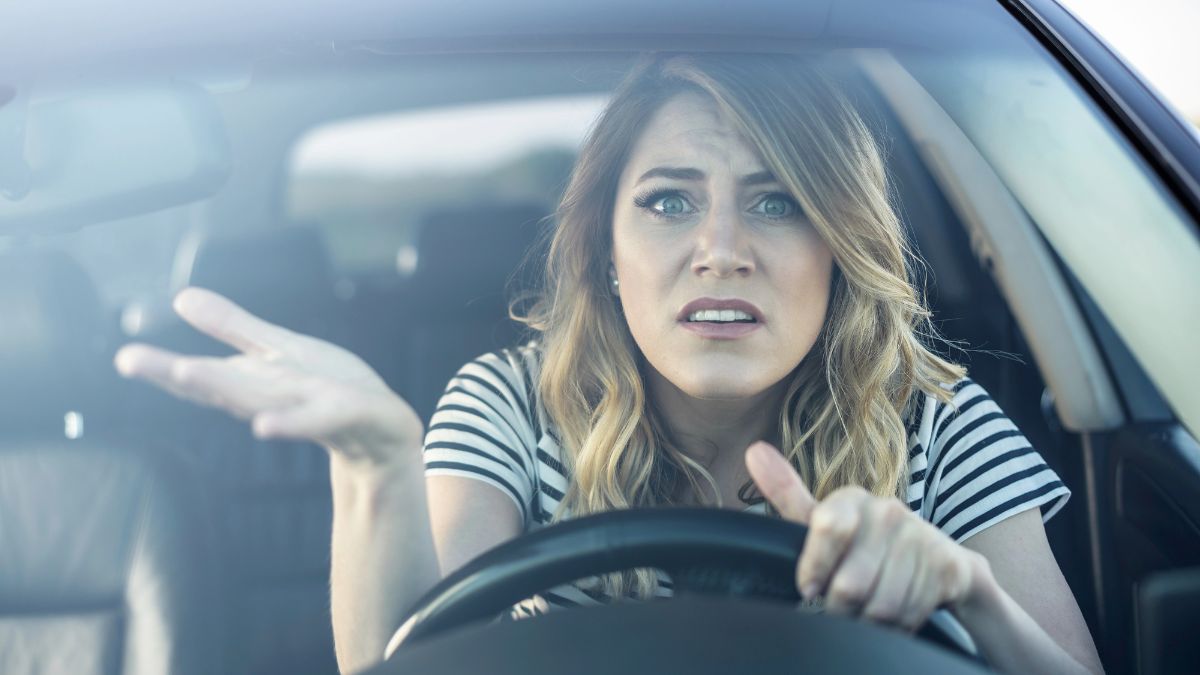 woman looking confused in driver seat